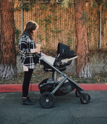 Mother pushing her baby in a stroller